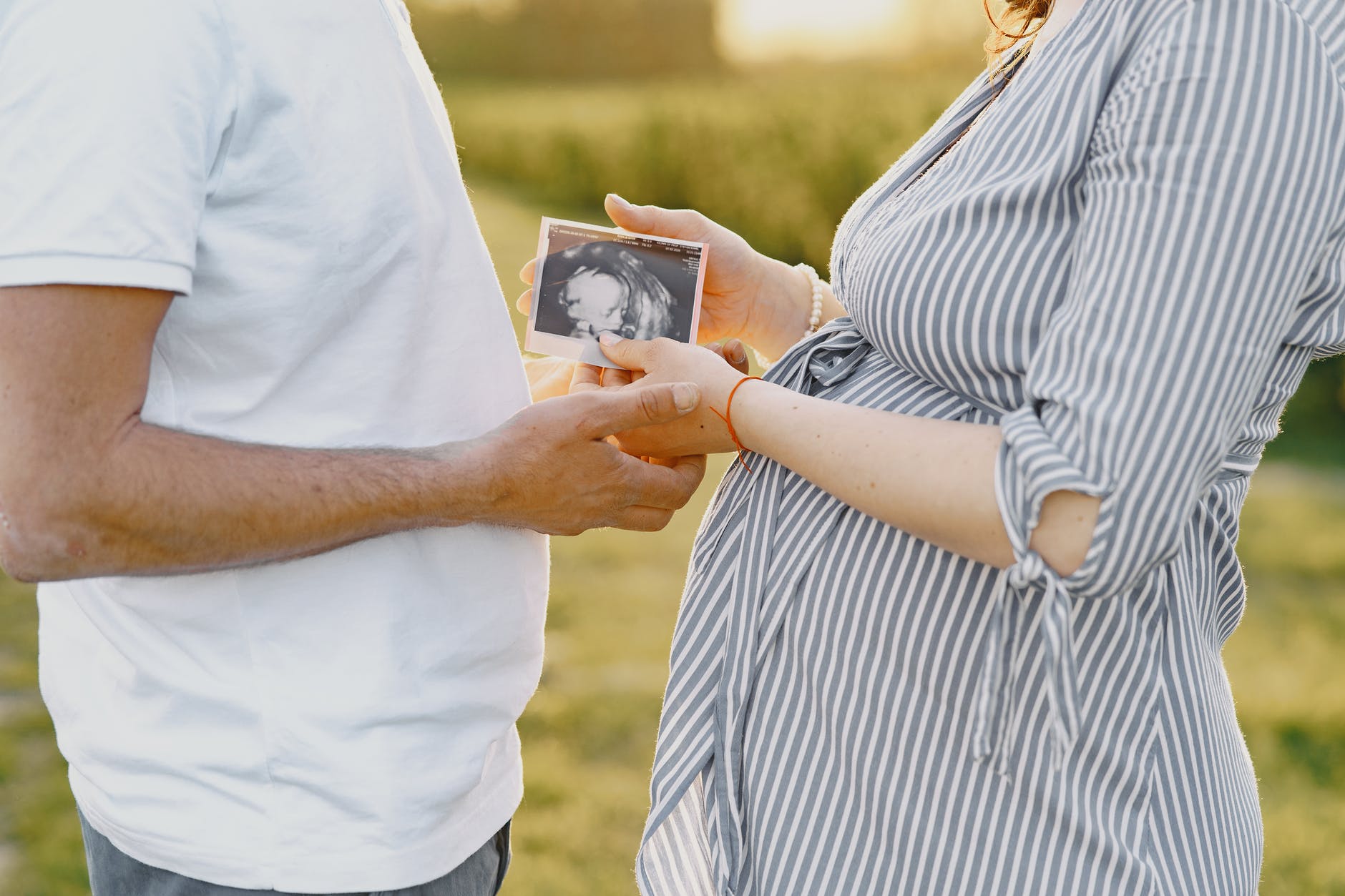 couple holding ultrasound photo