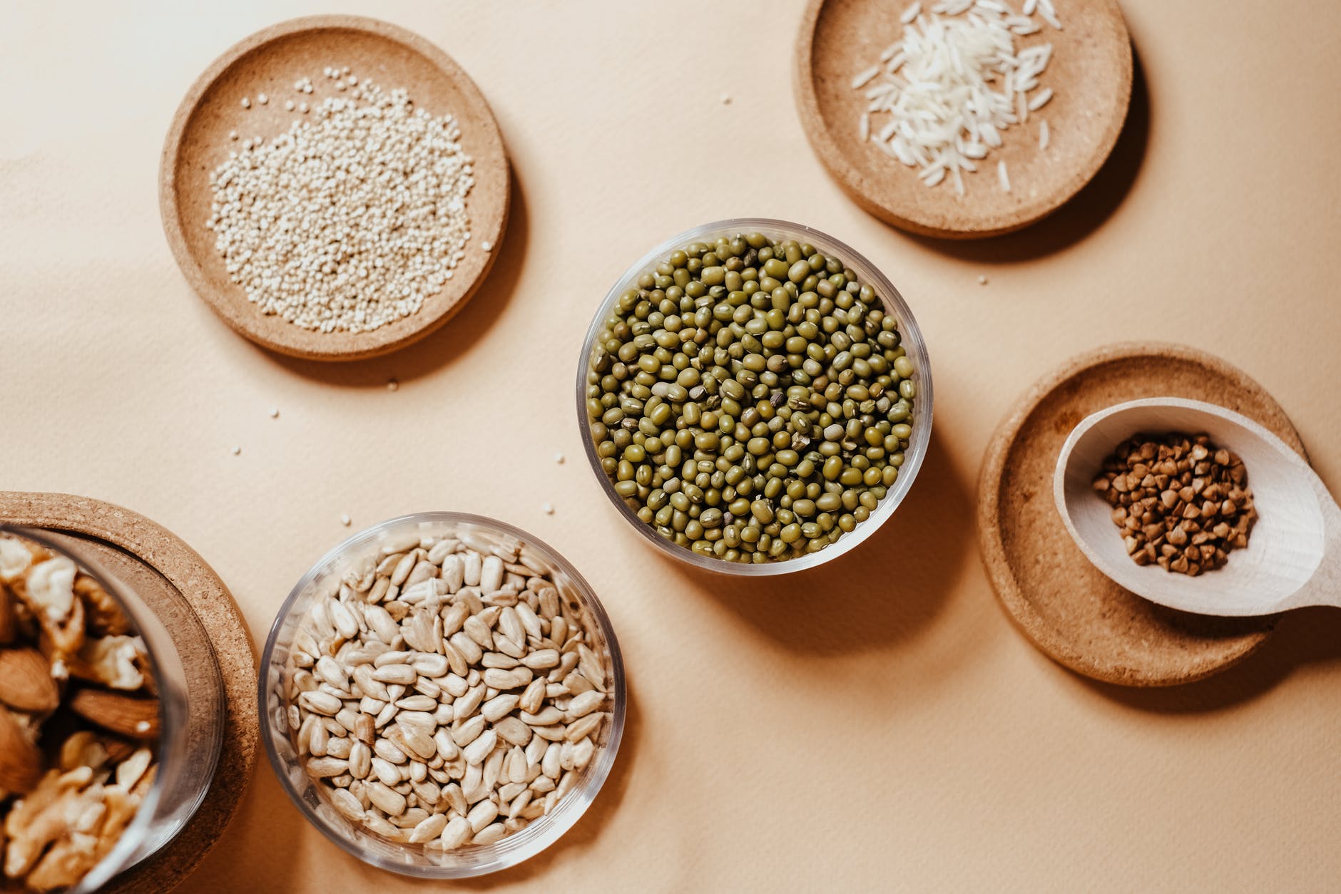 grains and seeds in glass jars and on saucers